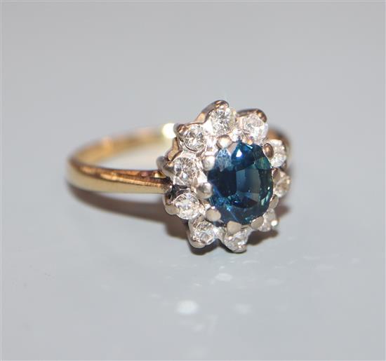 An 18ct gold,, sapphire and diamond oval cluster ring, size K.